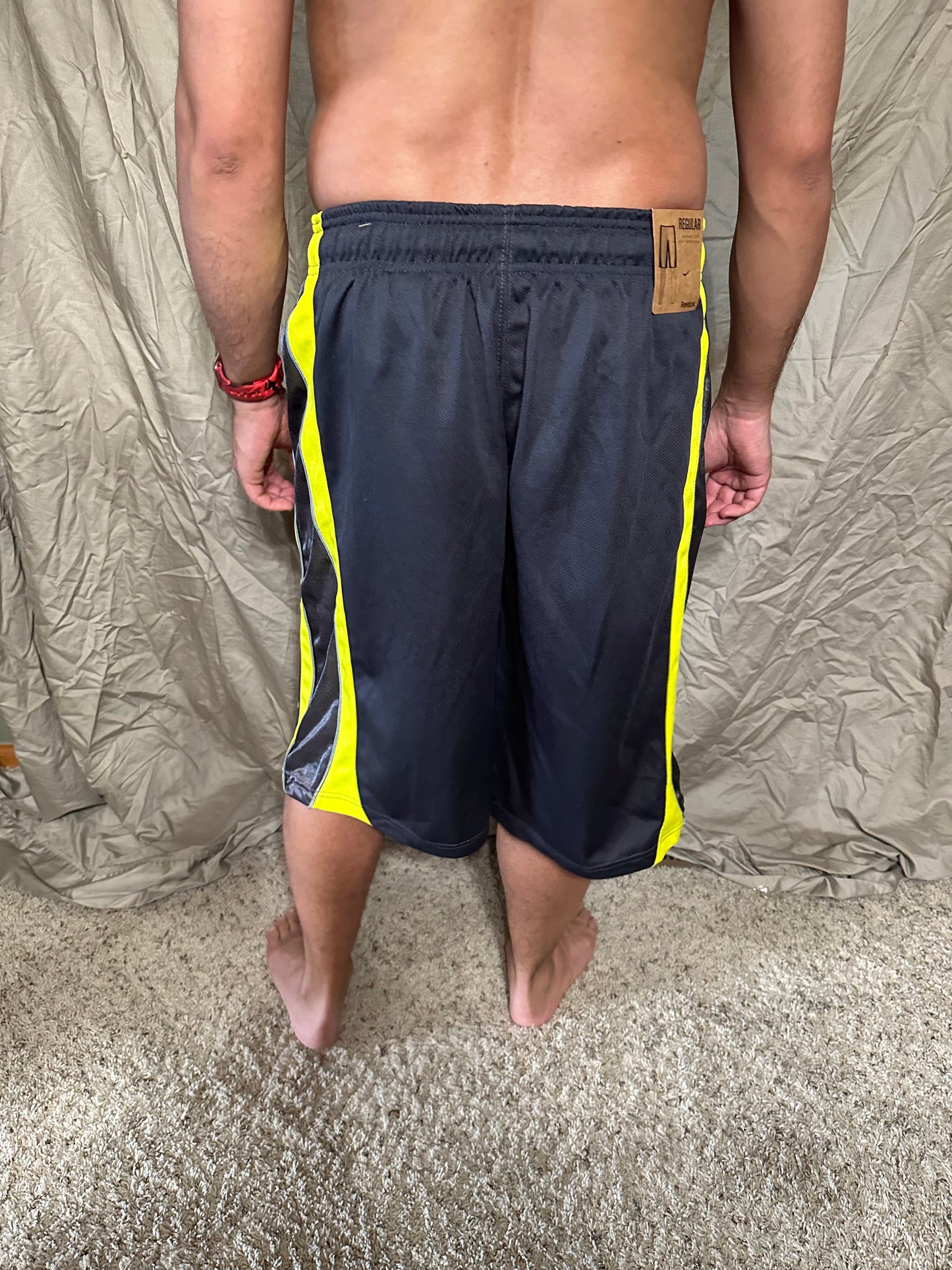 Men’s grey and yellow Reebok size medium performance athletic shorts with pockets
