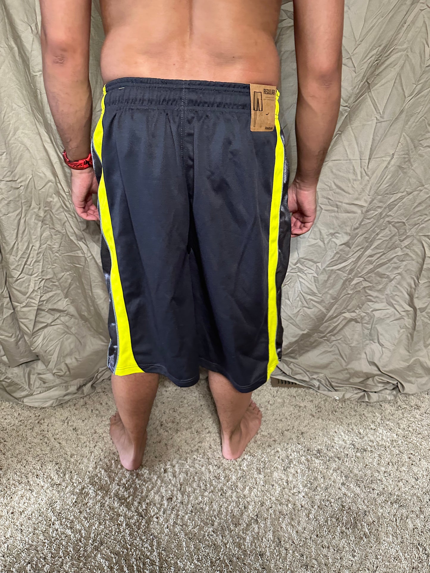Men’s grey and yellow Reebok size medium performance athletic shorts with pockets