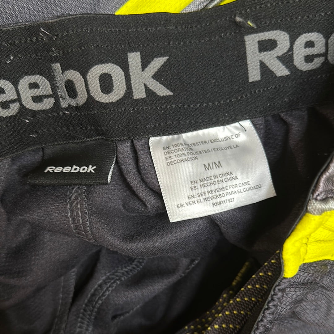 Men’s grey and yellow Reebok size medium performance athletic shorts with pockets
