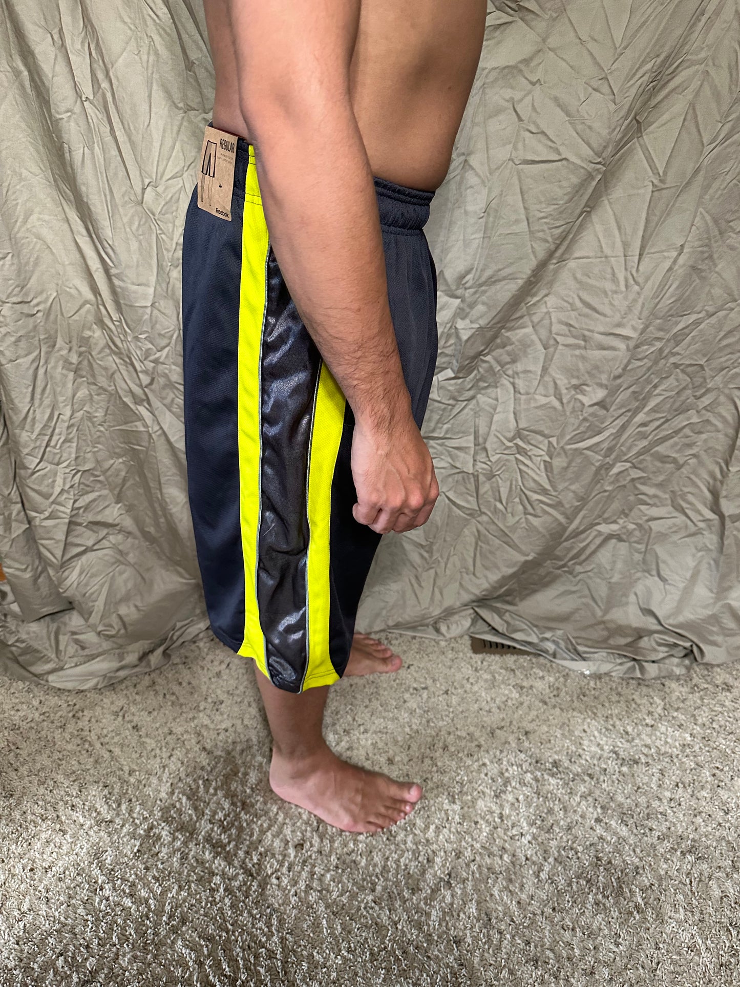 Men’s grey and yellow Reebok size medium performance athletic shorts with pockets
