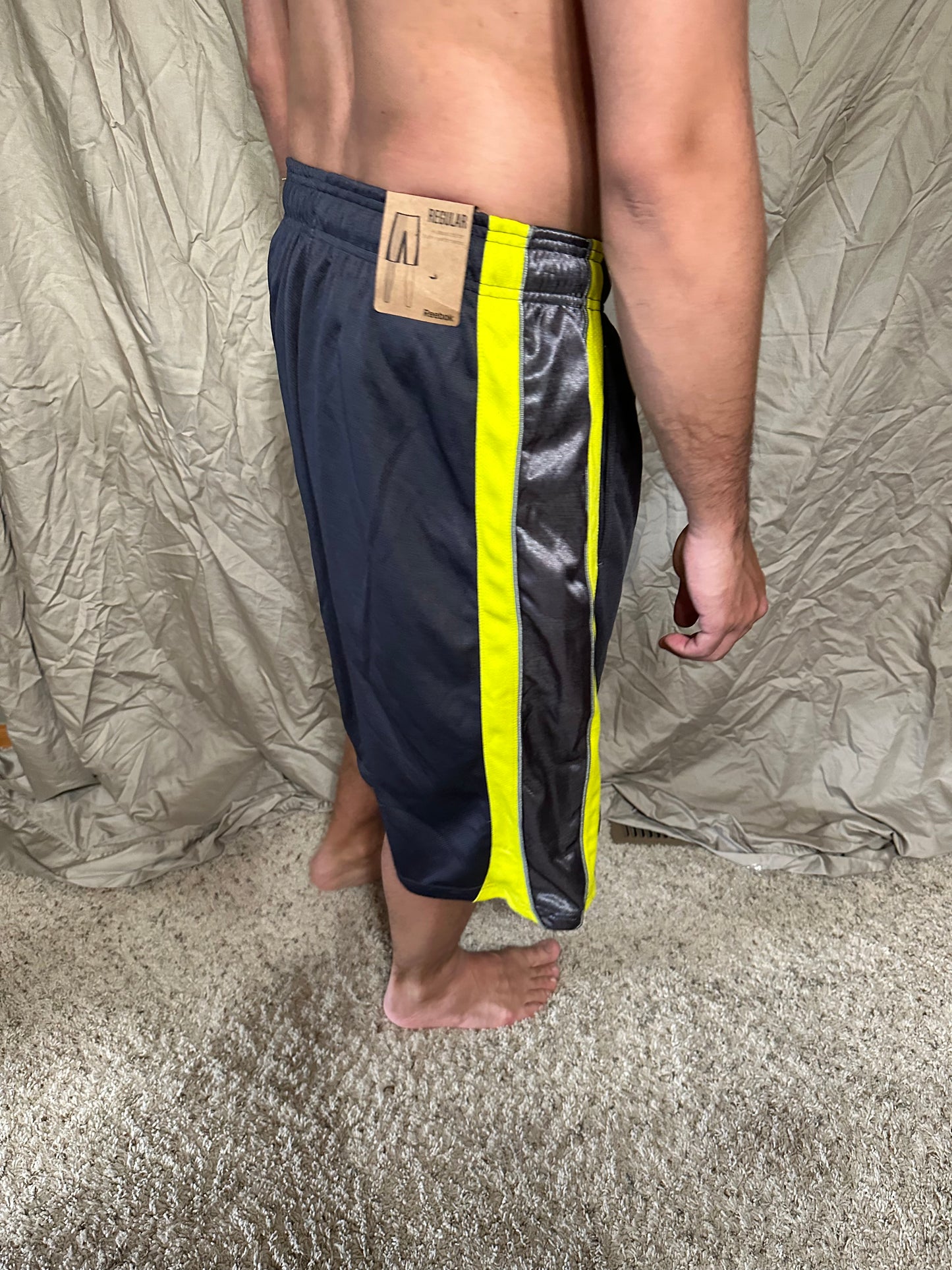 Men’s grey and yellow Reebok size medium performance athletic shorts with pockets