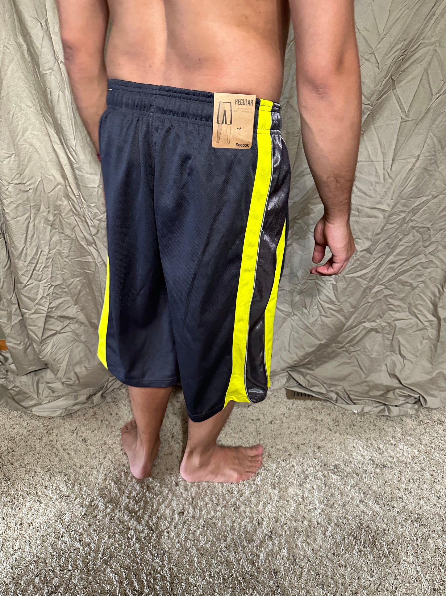 Men’s grey and yellow Reebok size medium performance athletic shorts with pockets