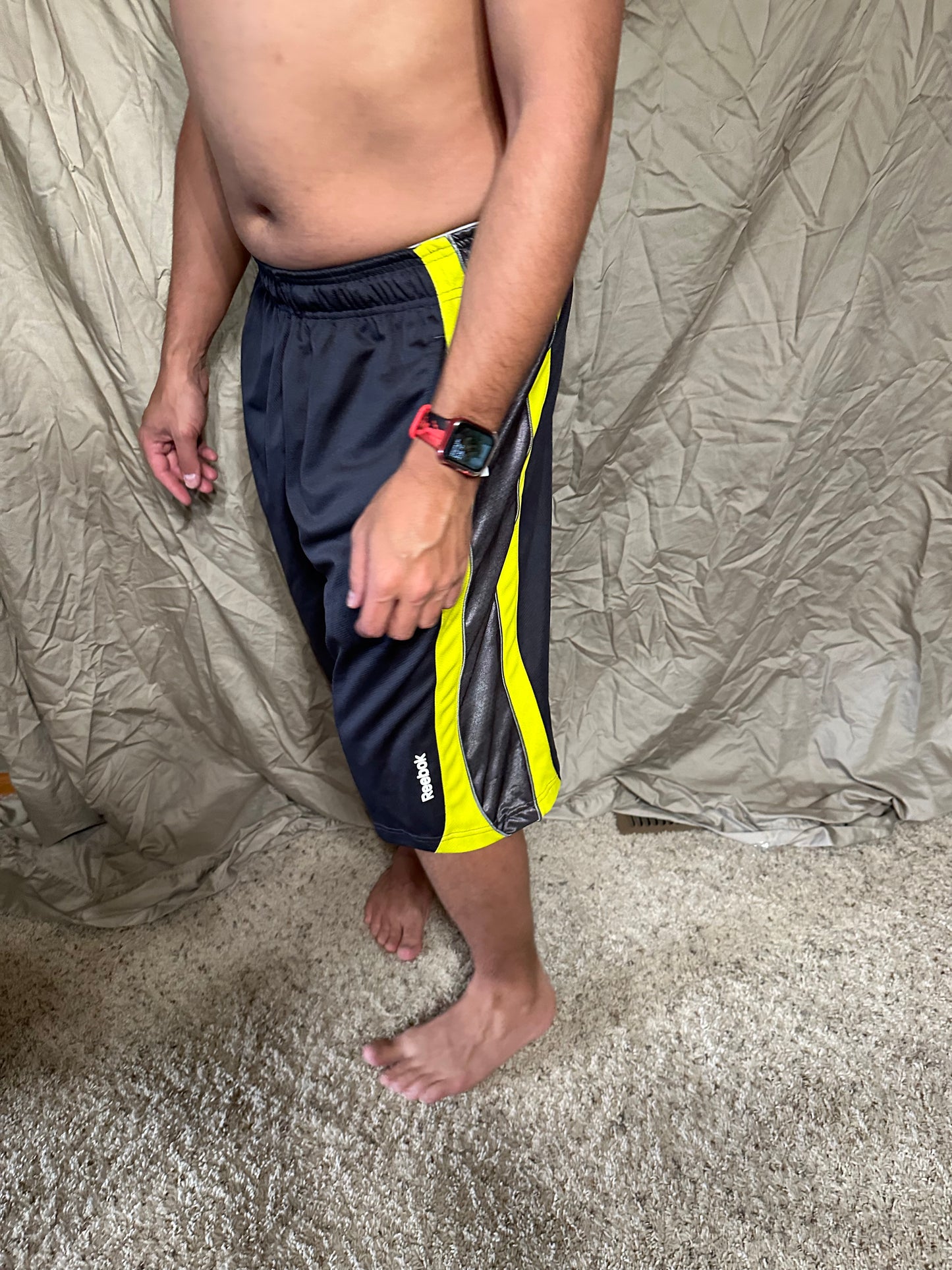 Men’s grey and yellow Reebok size medium performance athletic shorts with pockets