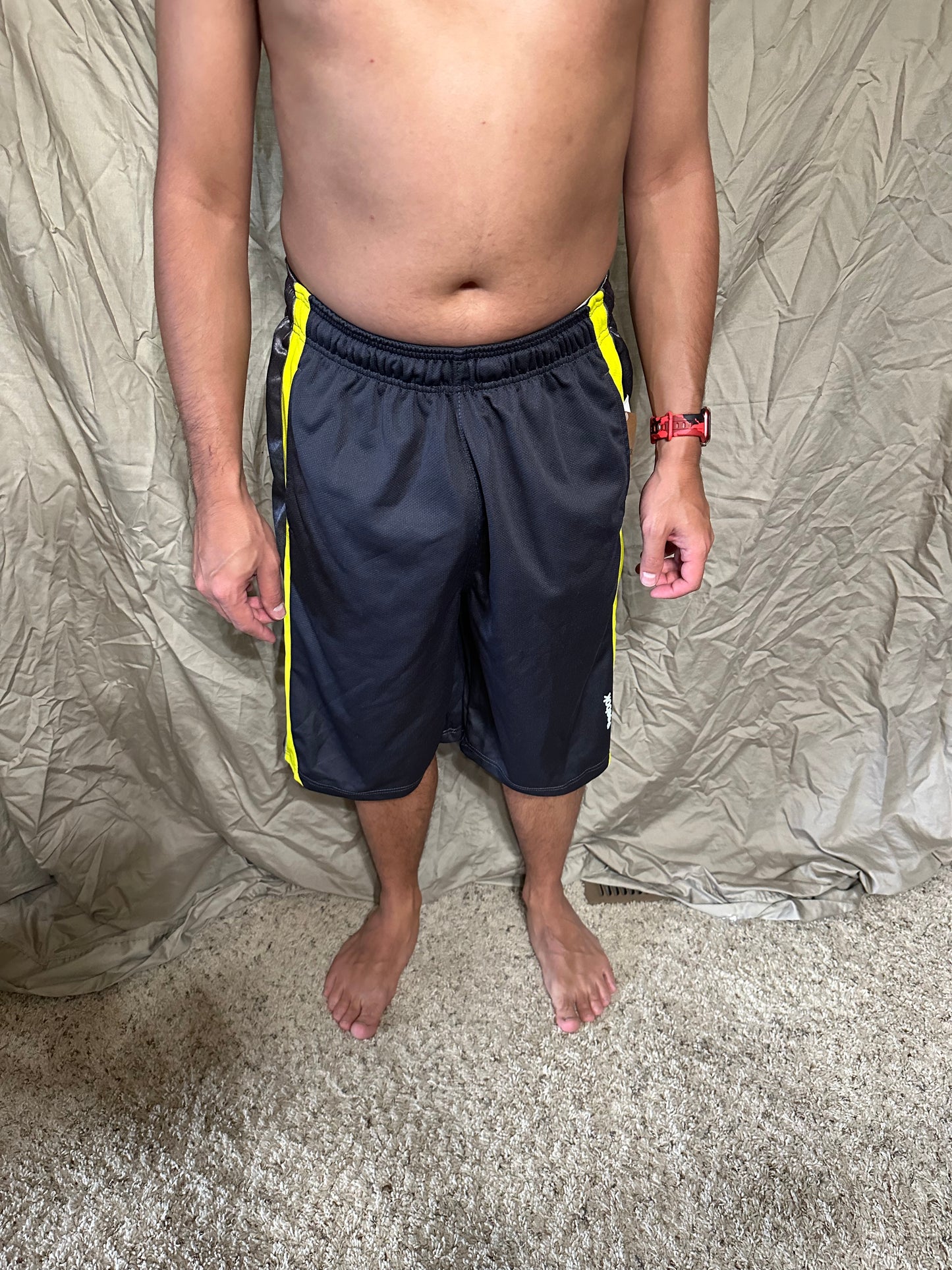 Men’s grey and yellow Reebok size medium performance athletic shorts with pockets