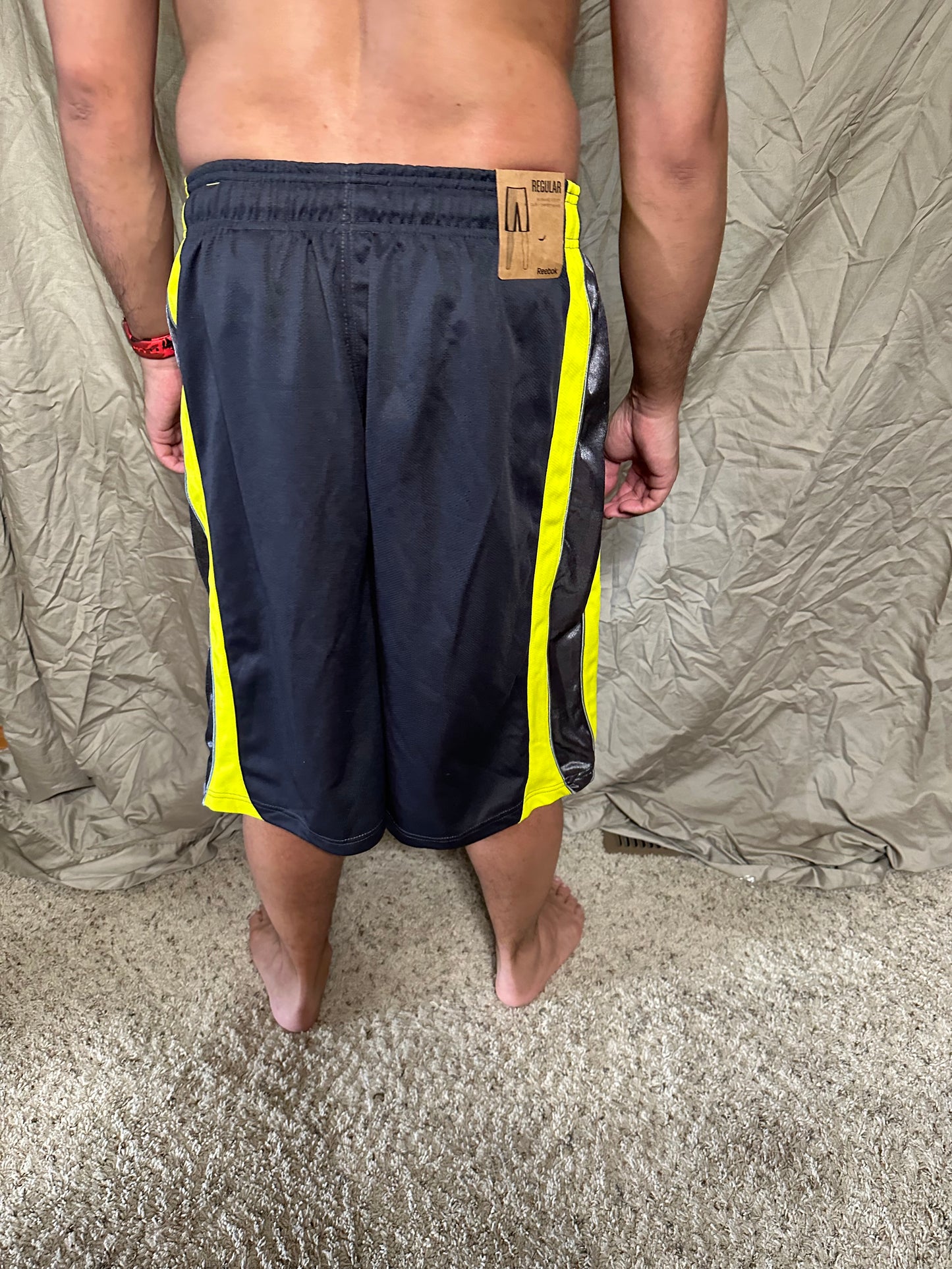 Men’s grey and yellow Reebok size medium performance athletic shorts with pockets