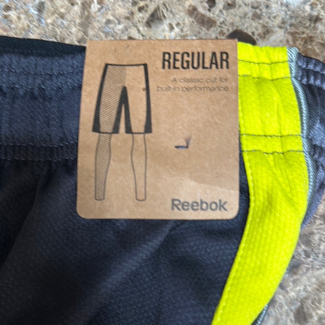 Men’s grey and yellow Reebok size medium performance athletic shorts with pockets