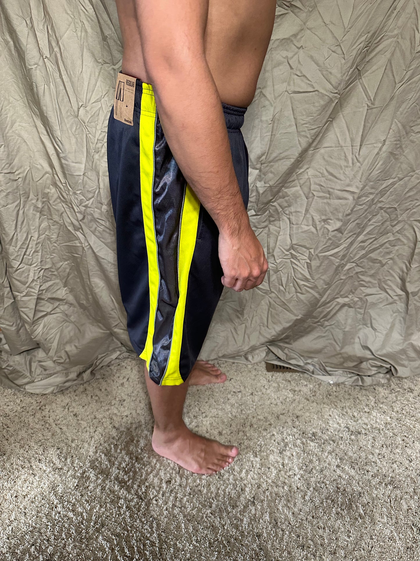 Men’s grey and yellow Reebok size medium performance athletic shorts with pockets